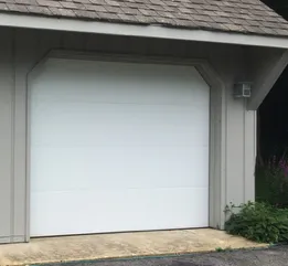 Clean modern flush insulated garage door on a Cape Cod home